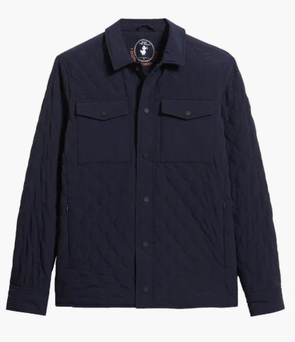 A man wears the SAVE THE DUCK Anton Jacket in navy—a dark blue, water-resistant jacket with buttoned chest pockets and a collar—paired with dark pants, standing against a plain white background.
