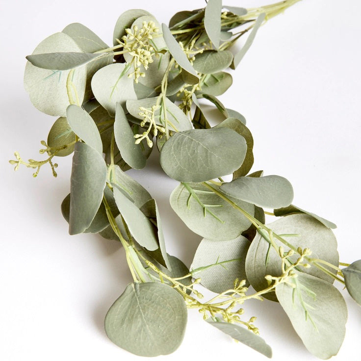 The NAPA HOME AND GARDEN - SILVER DOLLAR EUCALYPTUS SPILLER features cascading green leaves and small white flowers on slender stems, ideal for crafting a stunning greenery garland or centerpiece.