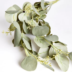 The NAPA HOME AND GARDEN - SILVER DOLLAR EUCALYPTUS SPILLER features cascading green leaves and small white flowers on slender stems, ideal for crafting a stunning greenery garland or centerpiece.