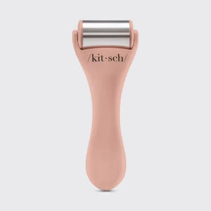 The beige packaging of the "KITSCH - ICE FACE ROLLER," featuring surgical stainless steel, suits sensitive skin. Made from recycled plastic, circular icons on it emphasize benefits like enhanced blood circulation.