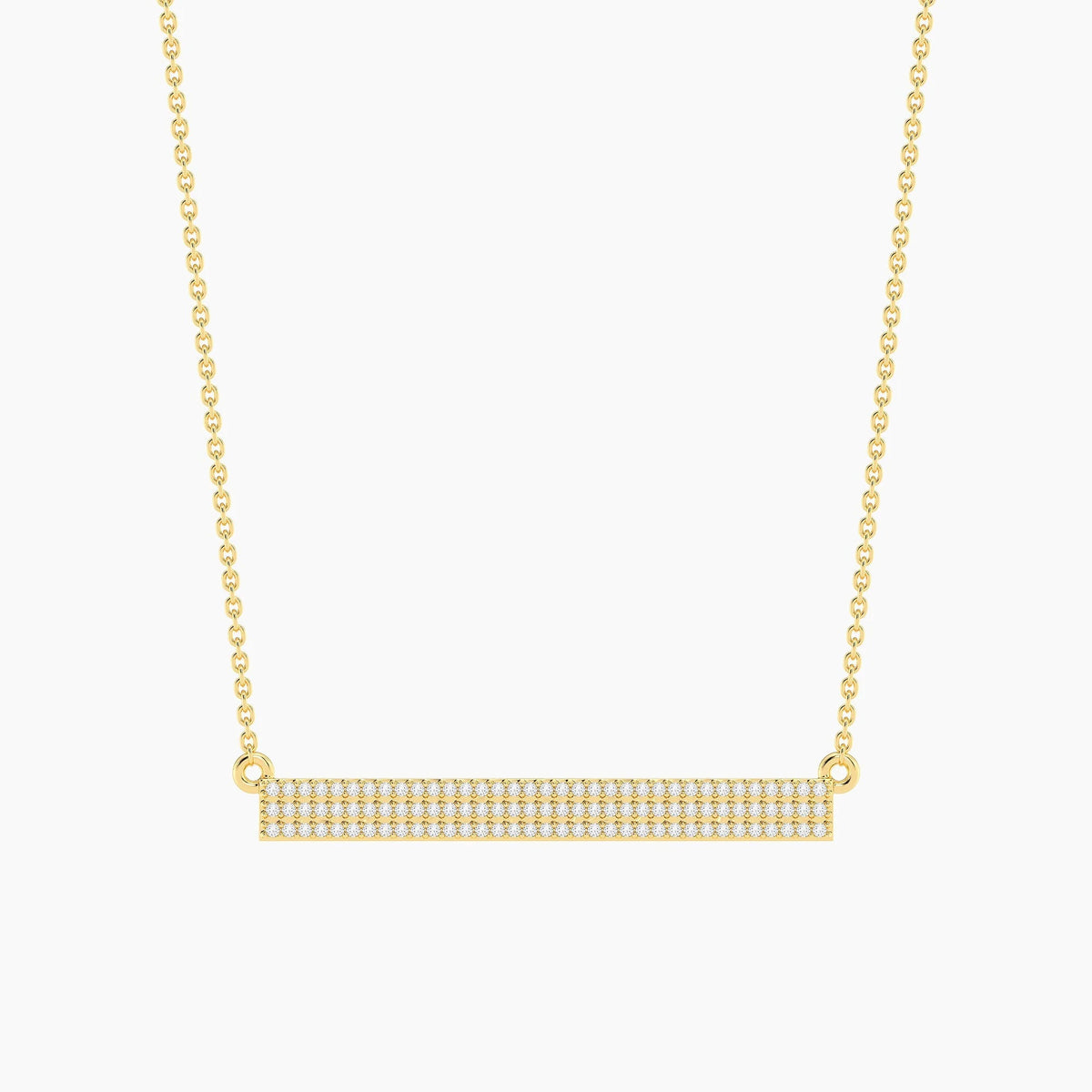 The ELLA STEIN - TELL ME STRAIGHT PENDANT NECKLACE by ELLA STEIN features a gold chain and a horizontal rectangular gold-plated pendant adorned with rows of small, sparkling stones. Displayed against a plain white background, this elegant stainless steel jewelry piece perfectly combines durability with timeless style.