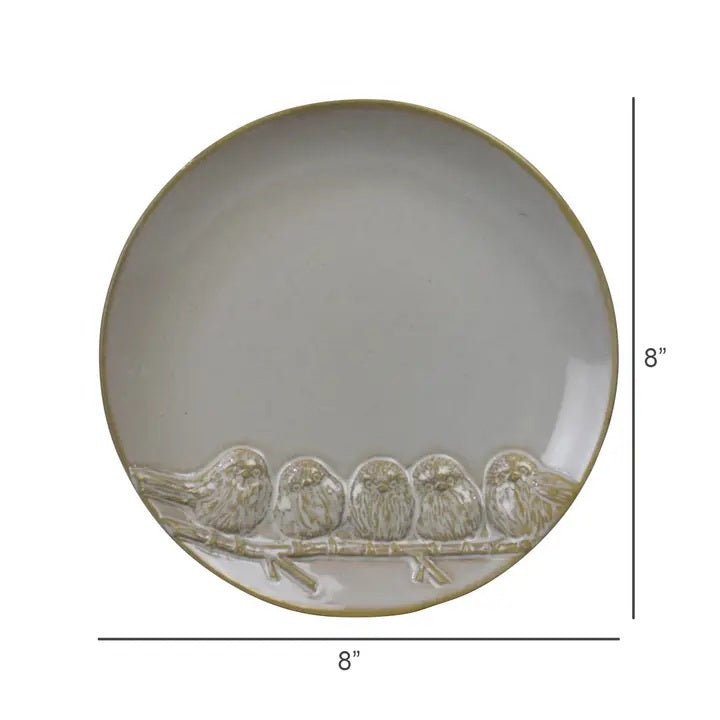 The HOMART CERAMIC TRAY WITH 5 BIRDS is a round, light gray tray featuring five embossed birds on a branch—ideal for serving cheese and crackers or as a unique hostess gift.
