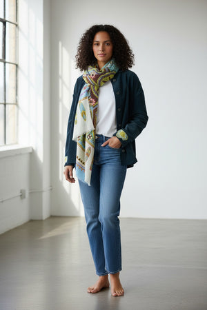 The STORIATIPIC ATHENA Wool Scarf with Embroidery in Ciel showcases blue, green, and beige tones with floral and geometric patterns, presented against a plain white background.