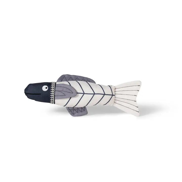 The FRINGE STUDIO - SOMETHING FISHY CAT TOY by PET SHOP BY FRINGE STUDIO is a plush kicker cat toy designed to look like a fish, featuring a dark blue head, grey fins, and a white body with linear patterns. Made from durable cotton canvas, the toy boasts a whimsical appearance with embroidered details such as a circular eye and stitched lines.