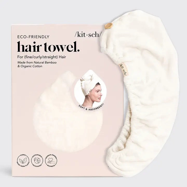 The KITSCH Quick Dry Hair Towel packaging highlights its luxurious eco-friendly blend of organic cotton and bamboo, showcasing softness and high absorbency. An image emphasizes friction-free drying, with the towel elegantly displayed beside the box, reflecting its natural allure.