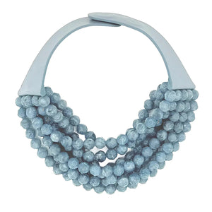 The FAIRCHILD BALDWIN - THE BELLA NECKLACE showcases layered strands of iridescent green Italian resin beads with a faceted design for a shimmering effect, finished with a smooth light green clasp that complements its vibrant hues.