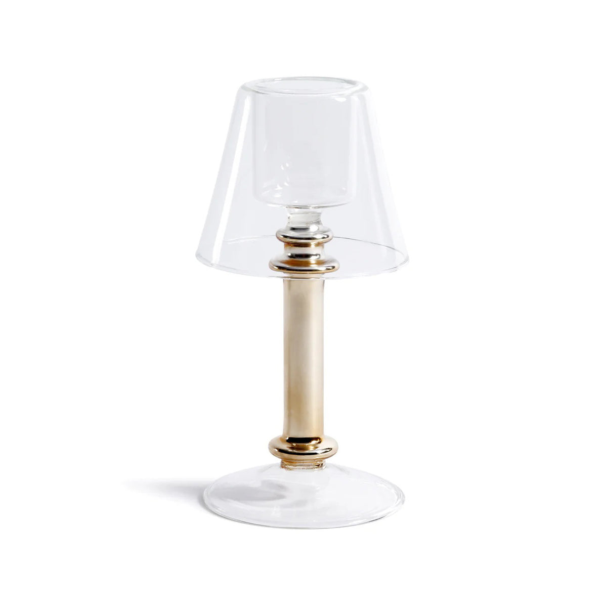 The ISOLA TEALIGHT LAMP by ZODAX features a clear glass lampshade, gold-tone cylindrical stem, and clear round base. Shown against a white background. Dimensions: 9.53 cm x 19.69 cm (3.75 in x 7.75 in).