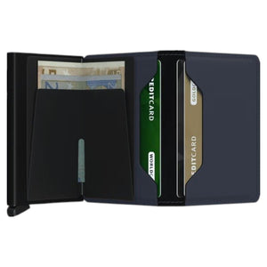 The SECRID - SLIMWALLET MATTE IN NIGHTBLUE stands upright, showcasing a slim, minimalist design with visible stitching, an embossed SECRID logo, and a black metallic edge featuring a small lever at the bottom. Like all SECRID wallets, this model provides RFID protection for enhanced security.