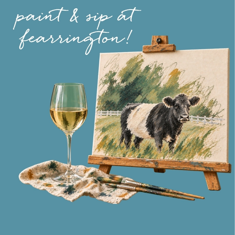 Guests seated at a table enjoy the PAINT &amp; SIP EVENING AT FEARRINGTON by FEARRINGTON VILLAGE, with blank canvases, paint palettes, brushes, paper cups, and a glass of white wine on the table.