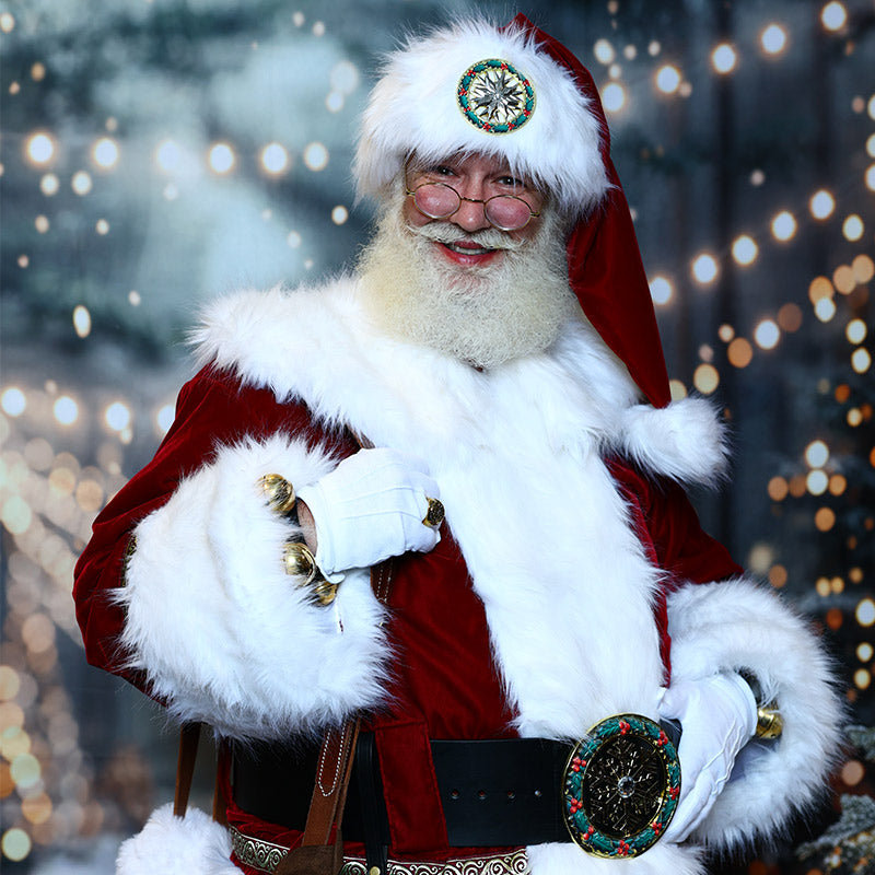 Santa Claus in a red velvet suit with fur trim and a decorated hat and belt buckle, attending the Fearrington Village Tea with Santa event.