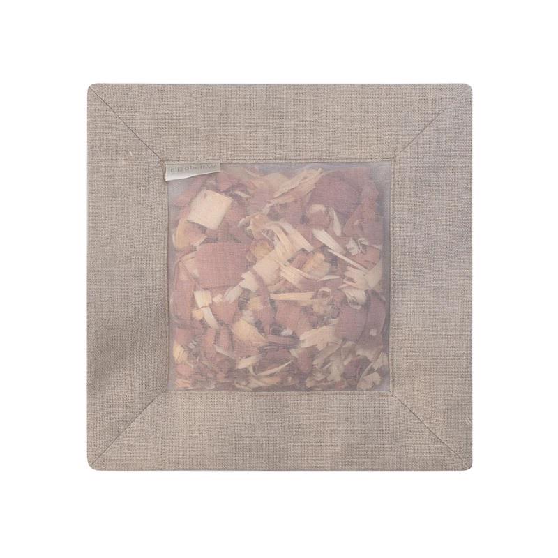 The &quot;CEDAR SQUARE SACHET NATURAL LINEN&quot; by E WIGHTMAN &amp; CO is a square-shaped beige linen pouch featuring a clear window that beautifully displays a blend of dried flower petals and aromatic cedar shavings. A small tag with text is attached to the top left corner of this 100% linen pouch, exuding natural charm.