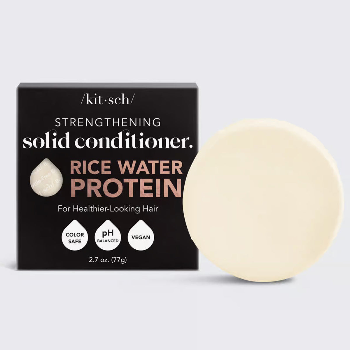 A round, off-white solid conditioner bar rests on its black and white packaging labeled "KITSCH - RICE WATER PROTEIN CONDITIONER BAR FOR HAIR GROWTH," promoting benefits for damaged hair repair. The product is color safe, pH balanced, and vegan.