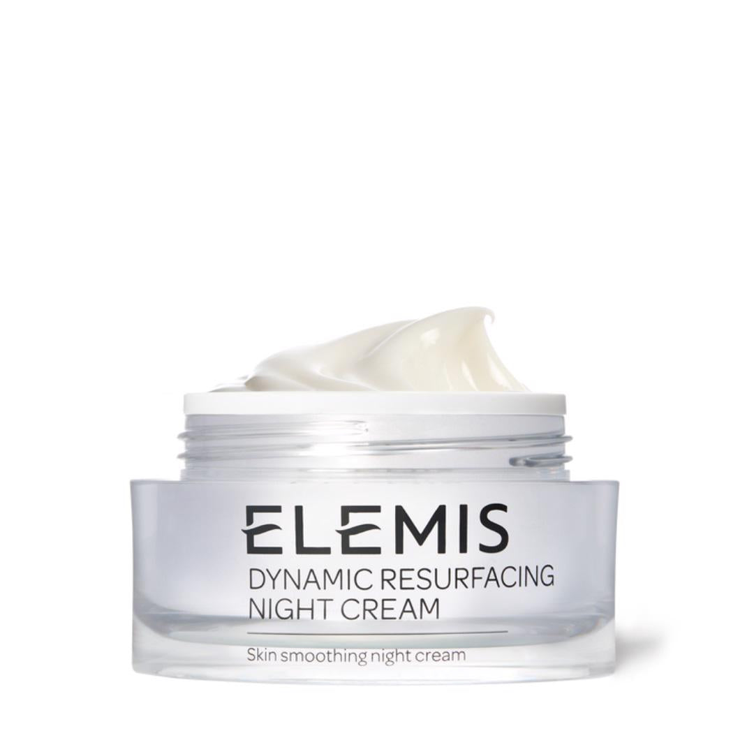 A clear jar with a wide white lid holds ELEMIS - DYNAMIC RESURFACING NIGHT CREAM 50ML, a skin-smoothing moisturizer enriched with Tri-Enzyme Technology. The jar features black text with the brand name &quot;ELEMIS - STEINER&quot; and product description &quot;Dynamic Resurfacing Night Cream&quot; and &quot;Skin smoothing night cream.&quot; The lid is partially open, revealing the cream inside.