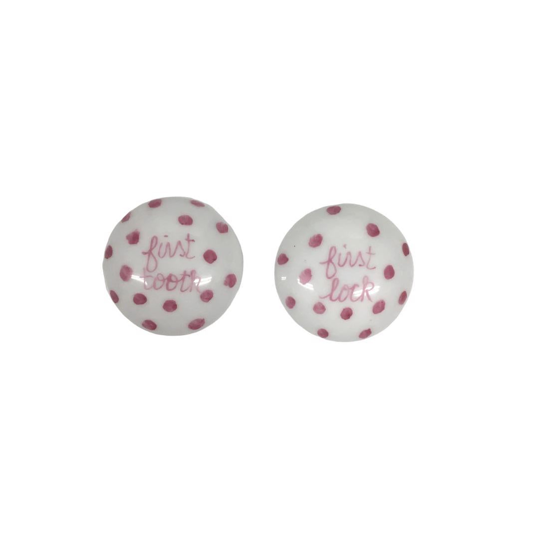 Introducing the TOOTH AND LOCK ELEPHANT (PINK) by ANN MARIE MURRAY, L.L.C., a bespoke porcelain set that includes a beautifully crafted plate and two small lidded containers. The plate showcases a hand-painted blue elephant with pink ears playing with a colorful ball, all surrounded by charming pink polka dots. The dotted lidded containers are thoughtfully labeled "first lock" and "first tooth.