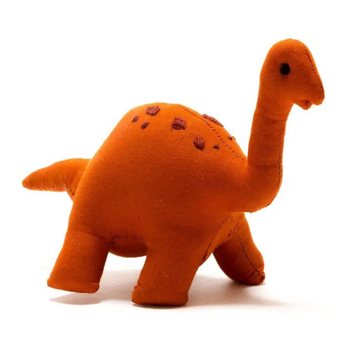 A handmade COTTON DIPLODOCUS DINOSAUR plush toy by BEST YEARS LTD, featuring an orange felt texture, a long neck, small black eyes, and resembling a brachiosaurus. This cotton dinosaur plush showcases embroidered spots on its back and stands on four legs against a plain white background.