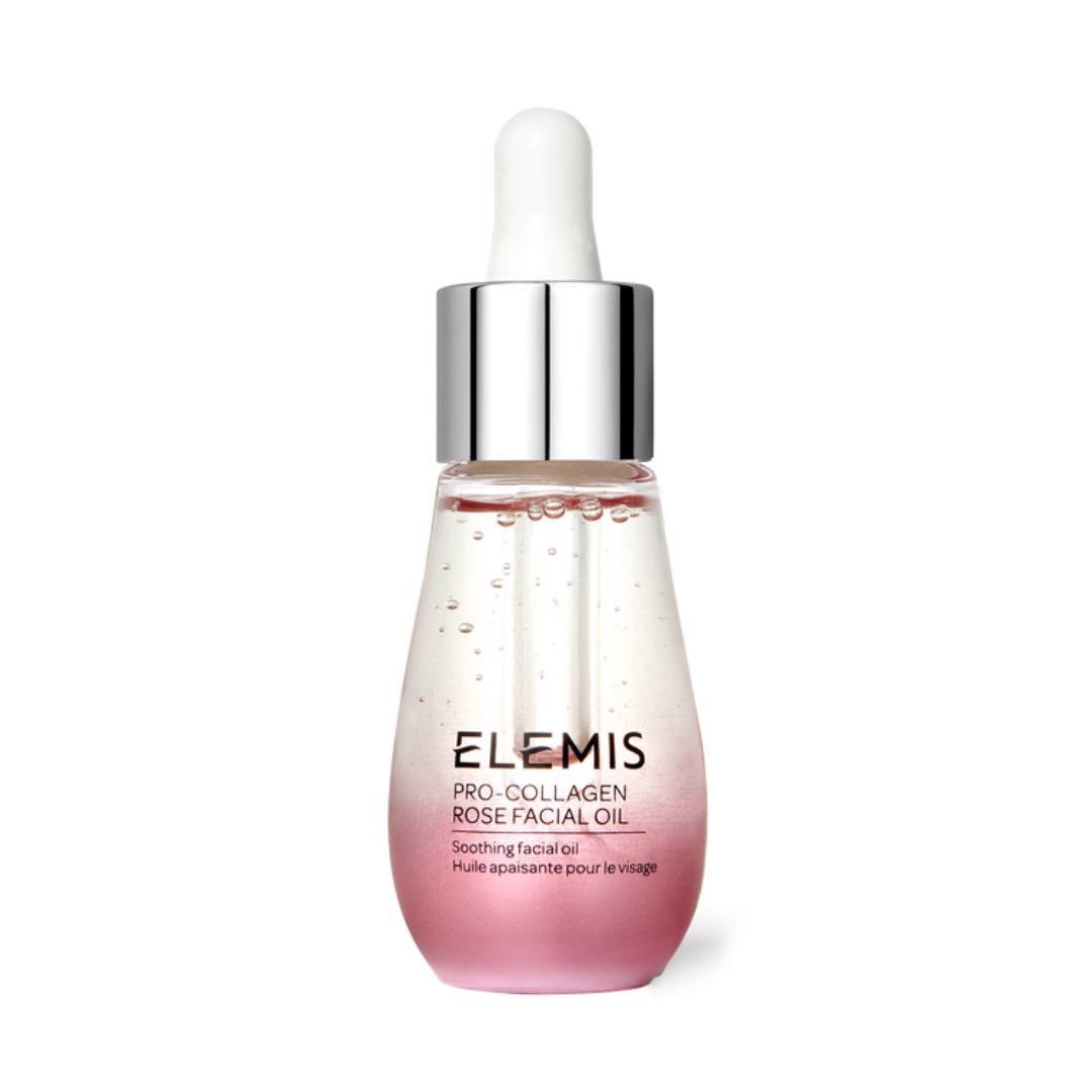 A bottle of ELEMIS - PRO-COLLAGEN ROSE OIL by ELEMIS - STEINER is shown. The bottle features a silver dropper cap and a gradient design, transitioning from clear to pink at the bottom. The label includes the product name and description, &quot;Soothing facial oil,&quot; in both English and French for a petal-soft complexion.