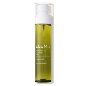 A green bottle of ELEMIS - Superfood Kefir Tea Mist from ELEMIS - Steiner, a hydrating mist that tones and sets makeup. The cylindrical bottle features a white pump dispenser and a clear cap. The label details the product&#39;s name and its advanced skincare benefits.