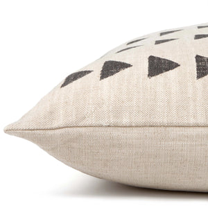 A close-up side view of a medium-sized, beige-colored rectangular dog bed from THE FOGGY DOG, featuring black geometric shapes, including triangles, on its surface. Made in the USA from durable cotton fabric, this plump dog bed showcases a woven texture. The background is white.