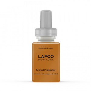 A rectangular, amber-colored bottle of LAFCO - SPICE POMANDER FOR PURA, featuring scents of cinnamon, bitter orange, and clove buds. The packaging is finished with a gray cap, while the brand name LAFCO and fragrance notes are printed on the front.