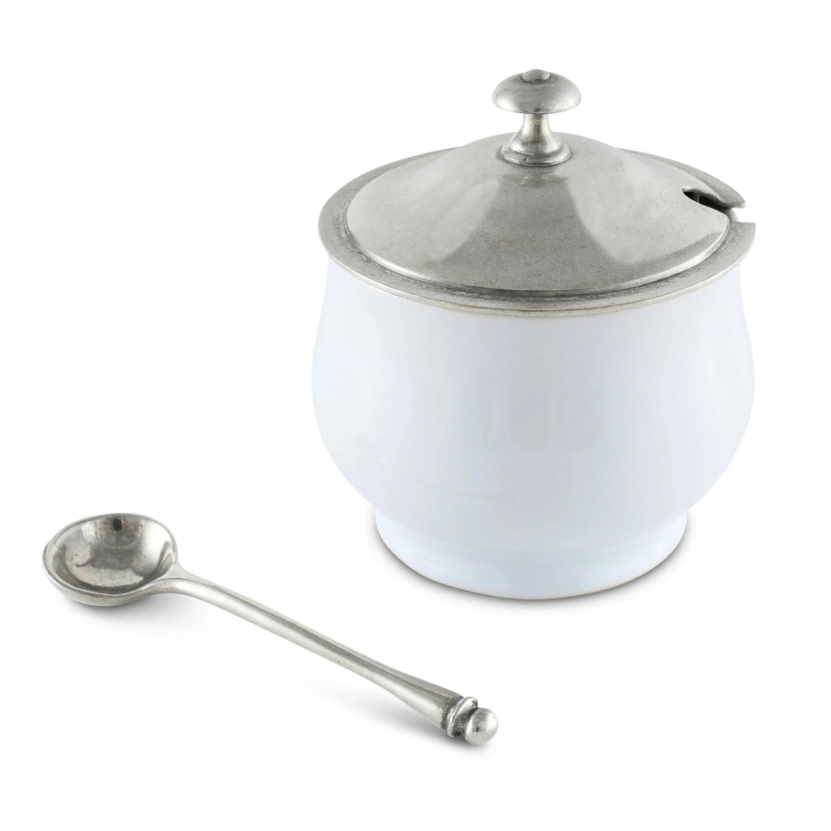 The VAGABOND HOUSE Classic Sugar Bowl, a white porcelain design with a luxury pewter lid and matching metallic spoon, features a small knob for easy lifting. A subtle notch accommodates the round, shallow spoon perfectly.