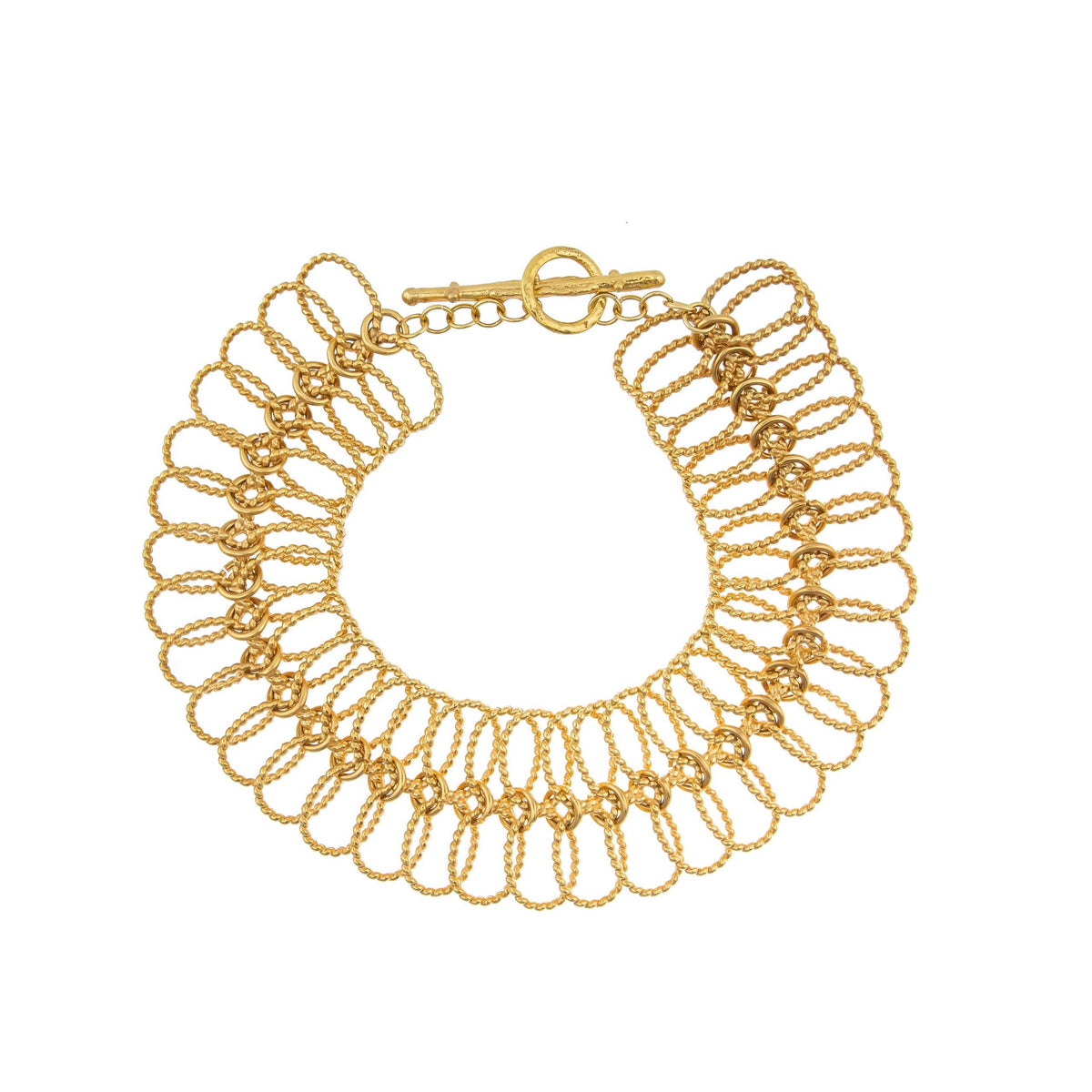 The SYLVIA TOLEDANO - XXL LINKS GOLD NECKLACE by STC SYLVIA TOLEDANO, crafted in gold-plated brass, features a spiral loop design with a toggle clasp. Displayed on a white background, its interlocking loops create a lace-like look reminiscent of talisman jewelry.