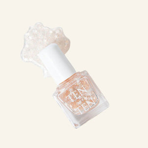 A glass bottle of TENOVERTEN - NAIL POLISH from the brand TEN OVER TEN, featuring a white cap and a dusty pink nail color. The front label displays "TEN OVER TEN" in white uppercase letters. This vegan, eight-free formula ensures both beauty and peace of mind. The background is plain and light-colored.