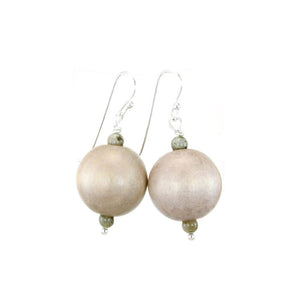 The ANN LIGHTFOOT - GREY WOOD DROP EARRING features large, round light beige beads as the main attraction. Each earring includes two smaller light grey wood beads above and below the central bead. The beads are elegantly attached to a sterling silver earwire, all set against a plain white background.