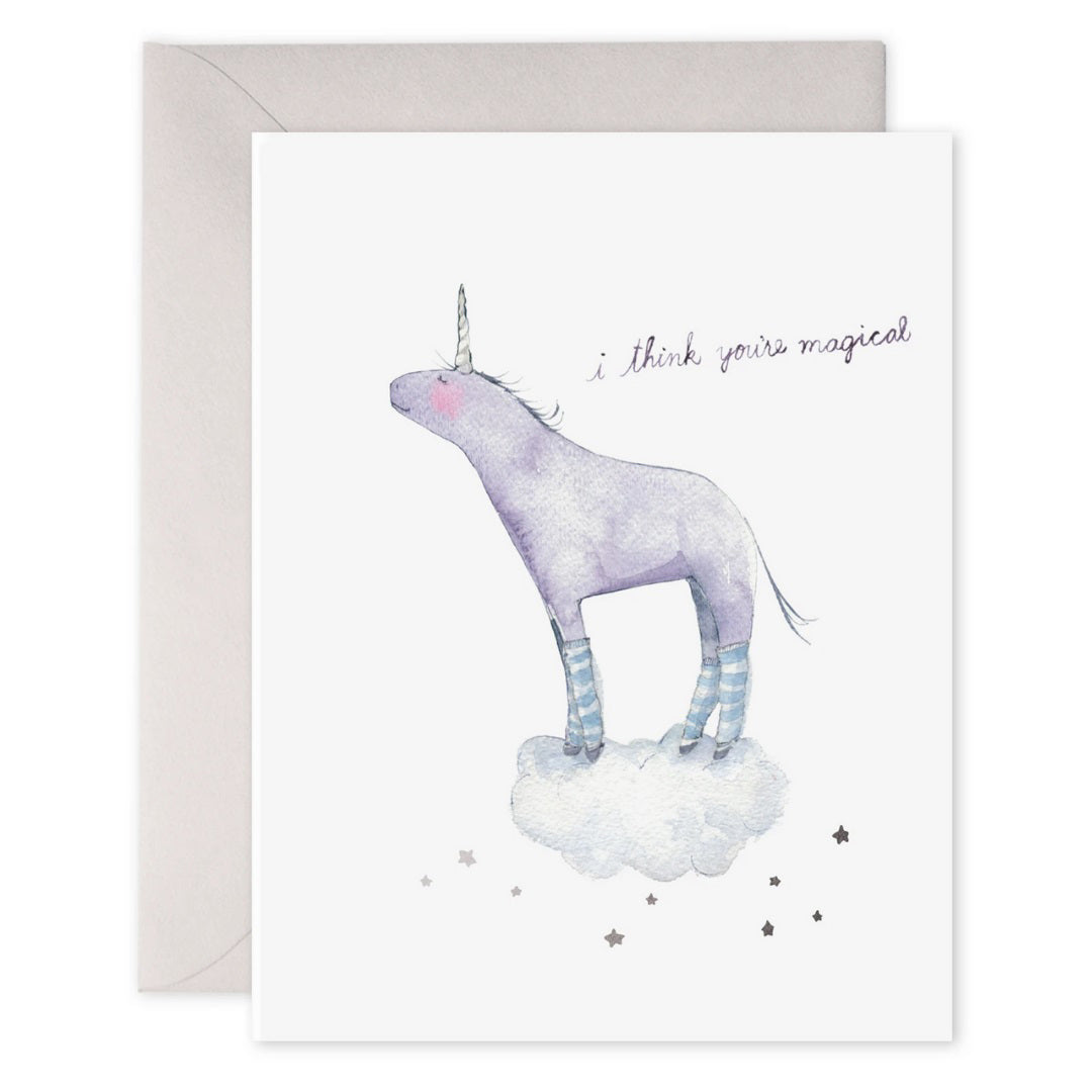The E. FRANCES PAPER - I THINK YOU'RE MAGICAL CARD features an original watercolor of a purple unicorn with striped legs on a cloud, accompanied by the handwritten message, "I think you're magical," highlighted by stars and printed on luxe heavyweight paper for elegance.