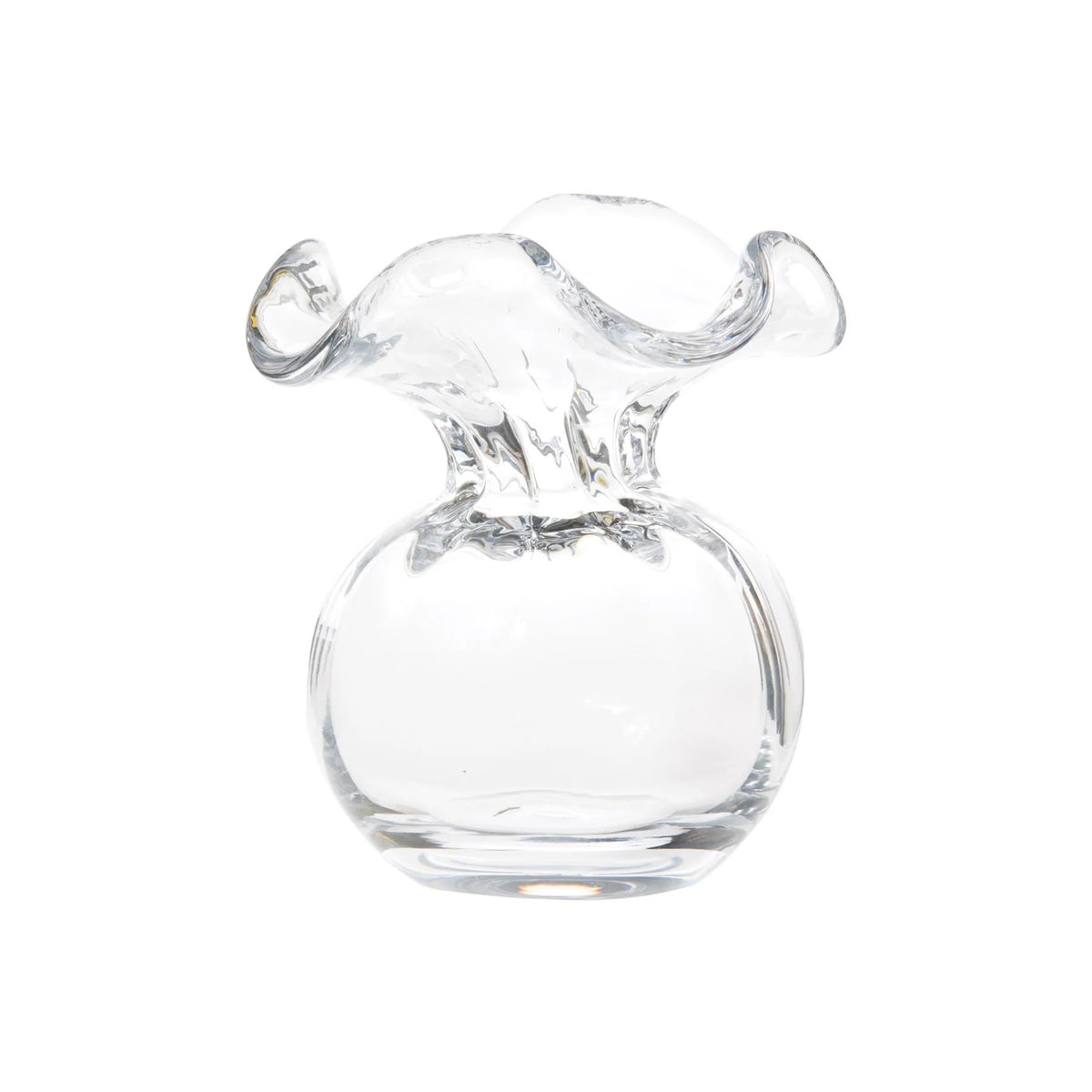 The VIETRI - HIBISCUS BUD VASE CLEAR by VIETRI features an artistic, wavy, and ruffled opening with a round base. This design resembles a blooming flower, crafted from smooth, transparent glass to showcase a modern and elegant aesthetic, making it perfect for any floral arrangement.