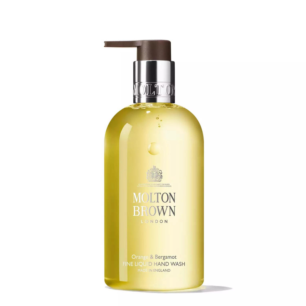 A clear bottle of Molton Brown Orange &amp; Bergamot Hand Wash featuring a pump dispenser. The luxury hand wash contains a yellow liquid infused with the essence of Sevillian orange and fragrant neroli. The bottle is labeled with the Molton Brown logo, and product details are printed in silver text.