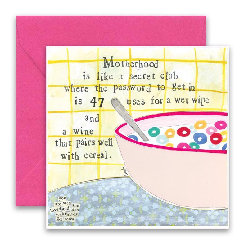 The CURLY GIRL DESIGNS - CEREAL GREETING CARD by CURLY GIRL DESIGN, INC showcases a hand-drawn image of a cereal bowl on a countertop. The card features text overlaying a tiled background that reads: "Motherhood is like a secret club where the password to get in is 47 uses for a wet wipe and a wine that pairs well with cereal." A pink envelope is included in the background.