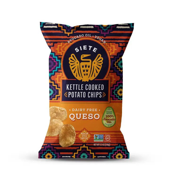 A vibrant bag of SIETE - KETTLE CHIPS QUESO CHEESE from SIETE FOODS. The packaging showcases a striking, Aztec-inspired design with geometric patterns in vivid colors. It is labeled as dairy-free, gluten-free, vegan, and cooked in avocado oil.
