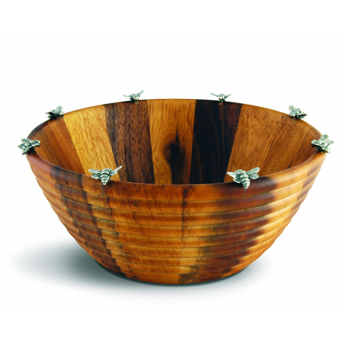 The VAGABOND HOUSE - BEE SALAD BOWL is a wooden serving dish with a ribbed design and pewter honeybee details on the rim. Made from acacia wood, it showcases a rich brown hue with natural grain patterns, enhancing any table setting elegantly.