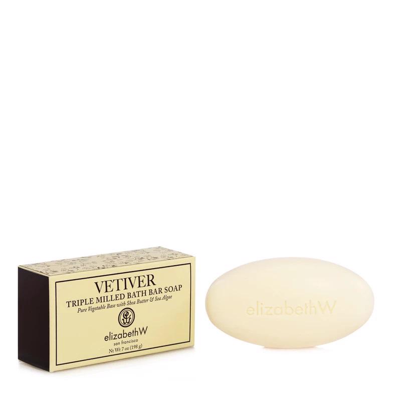 A beige bar of soap and its packaging are shown. The soap has the brand name "E WIGHTMAN & CO" embossed on it. The box beside it reads "VETIVER BAR SOAP" and mentions it contains pure vegetable base with shea butter, oat flour, and sea algae.
