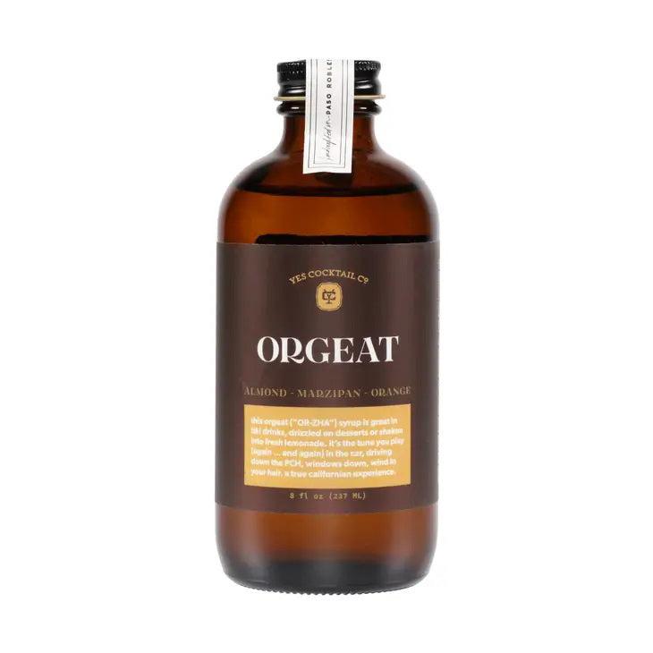 A dark amber glass bottle with a black cap labeled "YES OCKTAIL CO - ORGEAT SYRUP" by YES COCKTAIL CO. This exquisite cocktail syrup highlights almond, marzipan, and orange flavors. The 8 fl oz (237 ml) bottle embodies artisanal quality and balance in every drop.