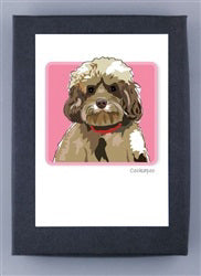 Introducing the PAPER RUSSELS - COCKAPOO BOXED CARDS by PAPER RUSSELLS: a charming collection featuring a framed illustration of a fluffy Cockapoo with curly fur, sporting a red collar against a pink background. These cards are proudly made in the USA and printed on FSC certified, recycled paper.