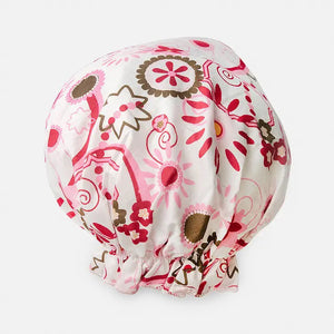 Introducing the BOUFFANT SHOWER CAP from BATH ACCESSORIES COMPANY! This stylish shower cap showcases a vibrant design of colorful macarons in shades of pink, purple, yellow, and brown against a lively green background. It features a waterproof inner layer to keep your hair dry and an elasticated bottom for a secure and comfortable fit.