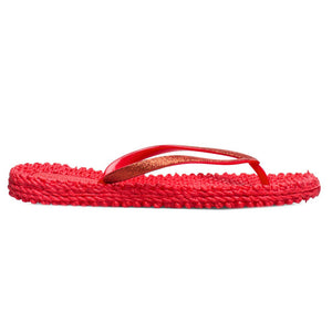 The ILSE JACOBSEN CHEERFUL FLIP FLOP IN DEEP RED by LINES OF DENMARK features vibrant red sandals with textured soles, glitter straps, and a comfortable fit, elegantly placed on a plain white surface.
