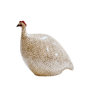 The LES CERAMIQUES DE LUSSAN Large Ceramic French Guinea in White Spotted Grey is a handmade sculpture featuring a rounded body with small beige spots, a white head with red and black accents, inspired by Heidi Caillard’s creations.