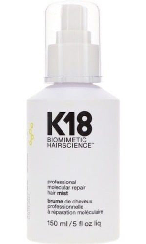 A white plastic bottle with a transparent cap, labeled "CARLO OLIVERI K18 MOLECULAR REPAIR HAIR MIST," describes itself as a "professional molecular repair hair mist" utilizing K18Peptide™ technology to repair damaged bonds and contains 150 ml (5 fl oz) of product.