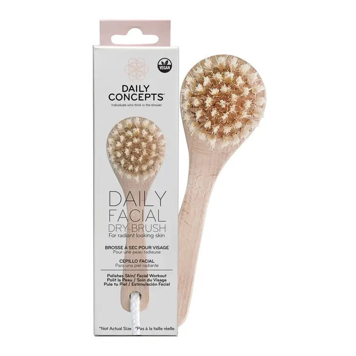In front of its packaging, the Wooden-handled FACIAL DRY BRUSH displays a photo of the brush, the brand name &quot;DAILY CONCEPTS,&quot; and text highlighting features such as &quot;Daily Facial Dry Brush&quot; and &quot;For Radiant Looking Skin.&quot; This exfoliating tool, which is perfect for lymphatic drainage, also boasts a Vegan logo on the top right.