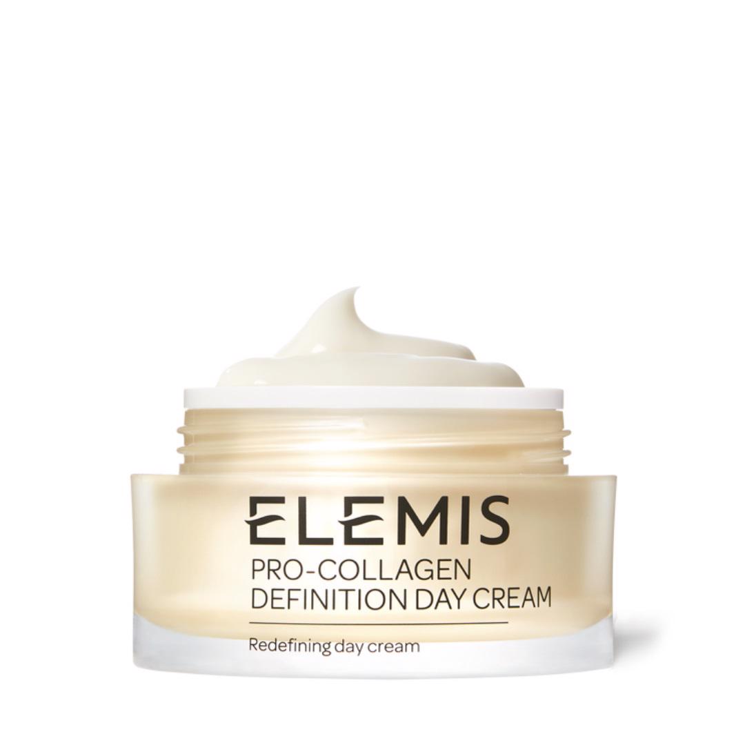 A jar of ELEMIS - PRO-COLLAGEN DEFINITION DAY CREAM by ELEMIS - STEINER, infused with plant stem cells. The container is transparent with gold accents and filled with a smooth, white cream. The text on the jar reads &quot;ELEMIS - PRO-COLLAGEN DEFINITION DAY CREAM&quot; and &quot;Firming day cream&quot; near the bottom.