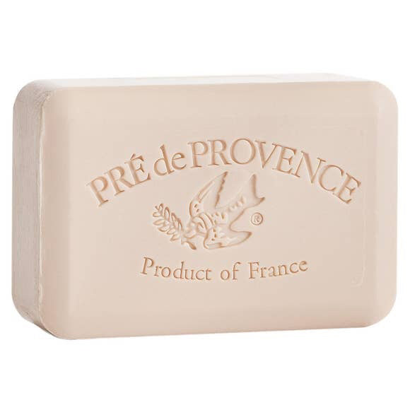 A 250g coconut bar soap from European Soaps, LLC, beige in color and rectangular with rounded edges. This French-milled soap is embossed with a bird carrying an olive branch and the text "PRÉ de PROVENCE Product of France" below it.
