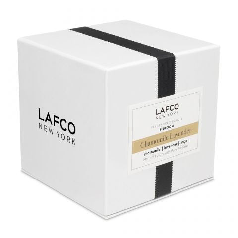 A small, cylindrical glass container filled with creamy yellow wax, resembling a candle. The unlit **LAFCO - BEDROOM CHAMOMILE LAVENDER 6.5OZ** by **LAFCO** casts a faint shadow on a white background and exudes a delicate hint of lavender.