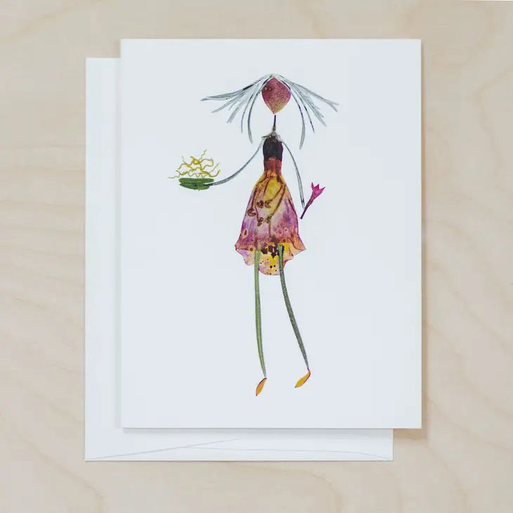 The PETAL PEOPLE PRESS - BON APPETIT CARD by PETAL PEOPLE PRESS showcases a whimsical, fairy-like figure with a heart-shaped head, long, slender limbs, and a colorful dress crafted from flower petals. Set against a plain, light background, this charming digital print art card is paired with a blank card for your personal message.
