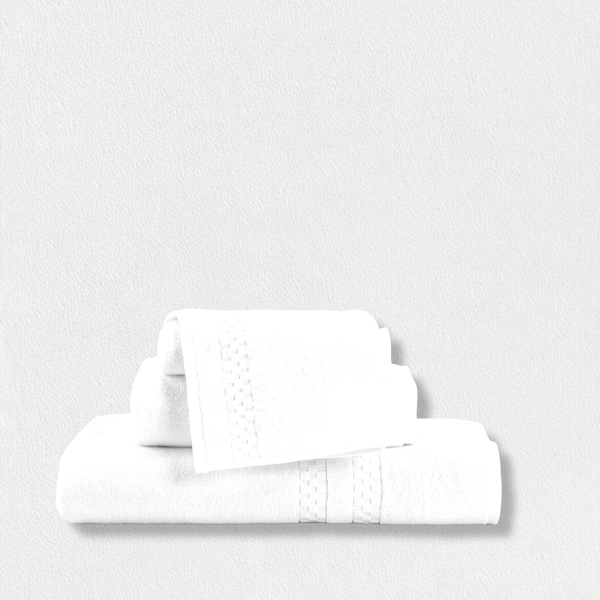 A neatly folded set of the Frette North America FEARRINGTON LIFESTYLE TOWEL COLLECTION - WASH CLOTH, made from 100% plush cotton, is stacked against a white background. These wash cloths, inspired by the elegance of Fearrington House Inn, feature a subtle decorative band pattern and vary in size. The overall aesthetic is clean, simple, and minimalist.