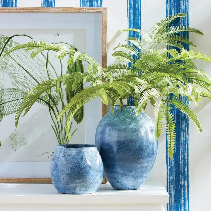 A NAPA HOME AND GARDEN - TREE FERN STEM features a lush green fern leaf against a white background, with wispy fronds branching elegantly from the central stem.
