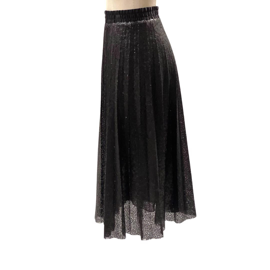 The BLACK SKIRT SEQUIN by SEVENTY is a knee-length, black pleated skirt made with shimmery textured fabric, perfect for an evening out. This fun skirt features an elastic waistband and is displayed on a white mannequin against a plain background.