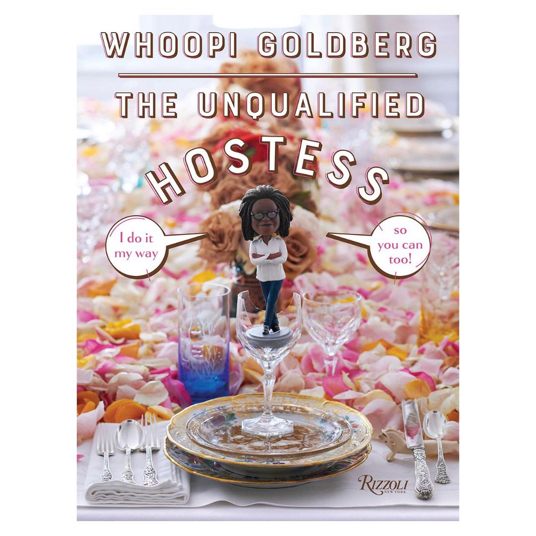 The cover of BOOK UNQUALIFIED HOSTESS by COMMON GROUND DISTRIBUTOR shows a figurine atop a glass above stylish plates and cutlery with petals, inspiring you to set a beautiful table and host celebrations in your own unique way.