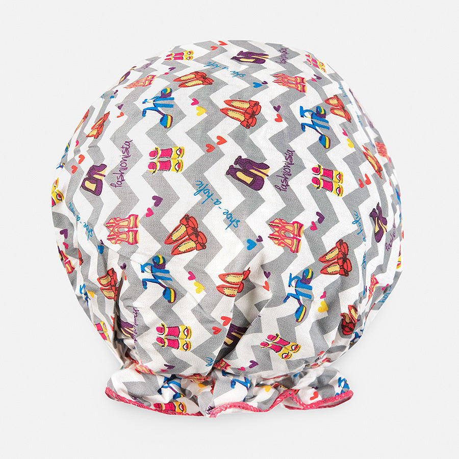 Introducing the BOUFFANT SHOWER CAP from BATH ACCESSORIES COMPANY! This stylish shower cap showcases a vibrant design of colorful macarons in shades of pink, purple, yellow, and brown against a lively green background. It features a waterproof inner layer to keep your hair dry and an elasticated bottom for a secure and comfortable fit.